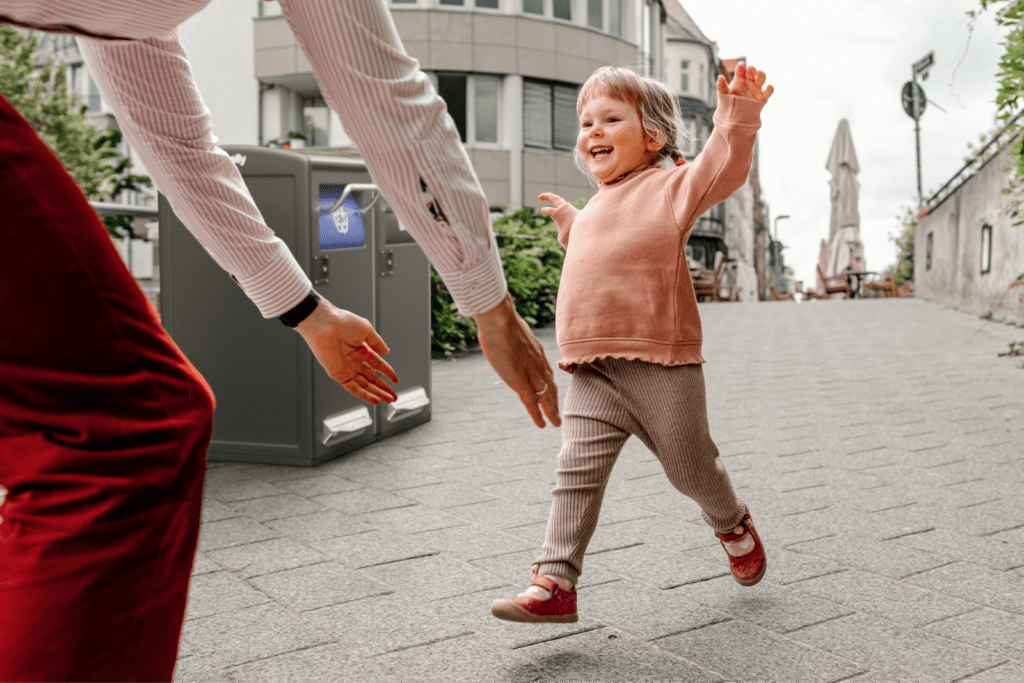 bigbelly trash can, recycling bin and solar compactor in clean city with kid and mom